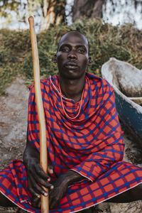 Portrait of young man sitting outdoors