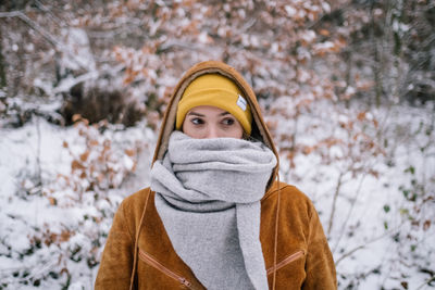 Woman in snow covered forest