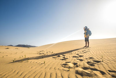 Full length of man standing on desert
