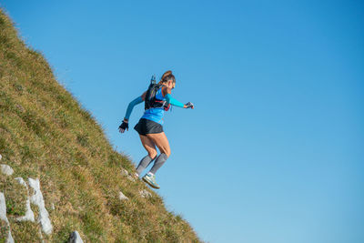 Girl running on the mountain peaks