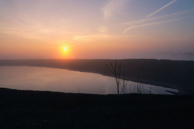 Scenic view of lake against sky during sunset