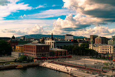 High angle view of river by buildings against sky