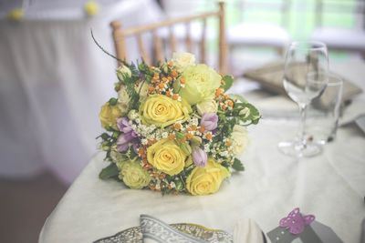 Close-up of rose bouquet on table during wedding