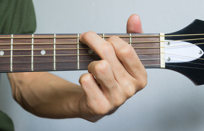 Midsection of man playing guitar