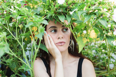 Thoughtful woman sitting alone outdoors. young worried in backyard