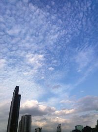 Low angle view of skyscrapers against blue sky