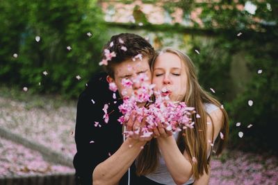 Couple blowing flowers