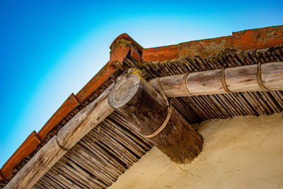 Low angle view of old building against blue sky