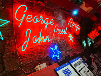 Low angle view of illuminated sign at night