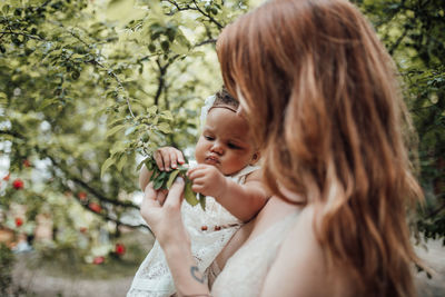 Mother and girl looking at tree