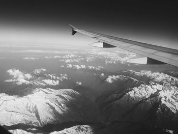 Airplane wing against sky