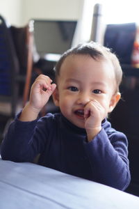 Close-up of cute boy looking through window