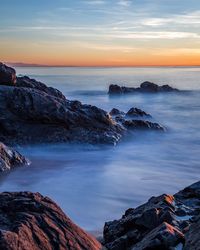 Scenic view of sea against sky at sunset