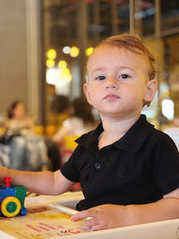 Portrait of boy on table