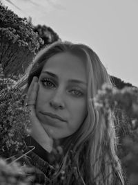 Portrait of a smiling young woman against sky