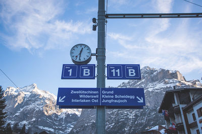 Low angle view of sign board against sky