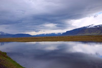 Scenic view of lake and mountains against sky