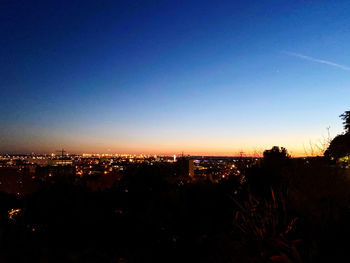 High angle view of illuminated buildings against sky during sunset