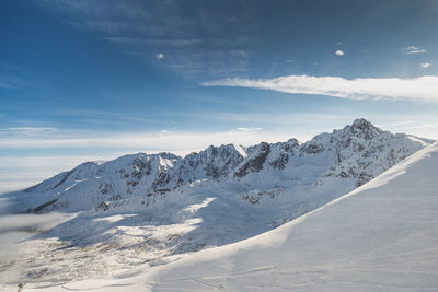 Scenic view of snowcapped mountains against sky