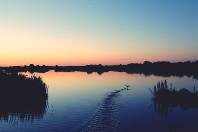 Scenic view of lake against sky during sunset