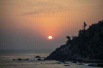 Scenic view of sea against sky during sunset