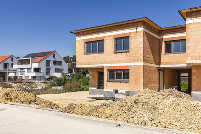 Germany, bavaria, elchingen, freshly dug dirt in front of brick suburban house