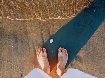 Low section of man standing beach