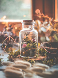 Close-up of glass of jar on table in a magic atmosphere