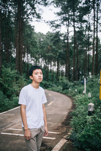 Full length of man standing in forest