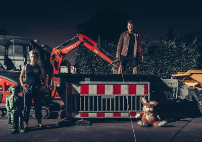 People standing with dog at night