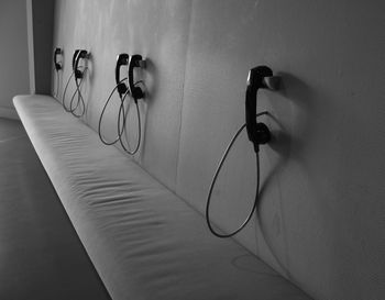 Landline phones on wall over empty seat