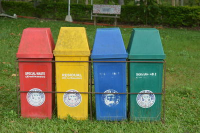 Four trash bins on grass