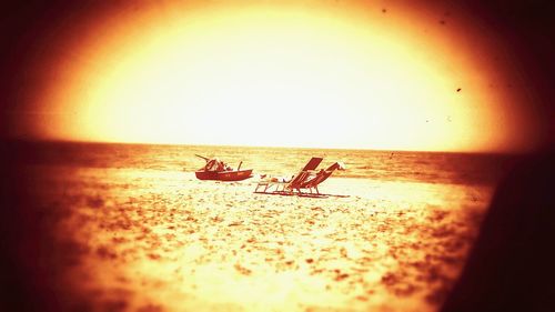 Scenic view of sea against clear sky at sunset