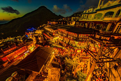 High angle view of illuminated buildings in city at night