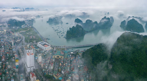 High angle view of city by buildings against sky