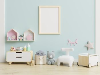 Picture frame hanging on wall with toys on floor