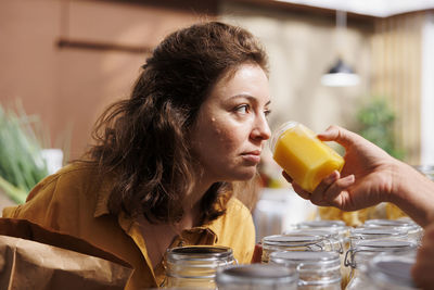 Close-up of young woman drinking juice