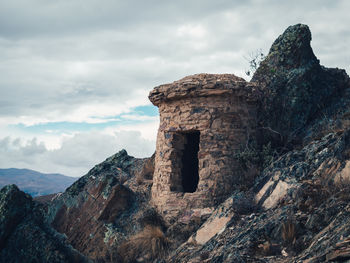 Rock formations on mountain against sky