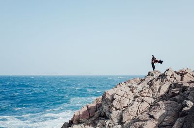 Young woman overlooking calm blue sea