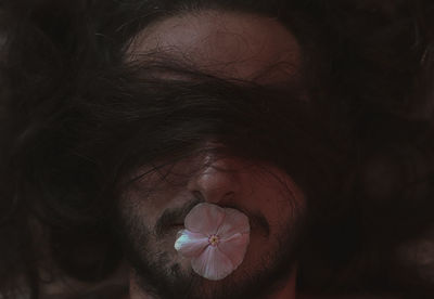 Close-up of man face with flower hair