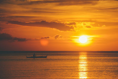 Scenic view of sea against orange sky