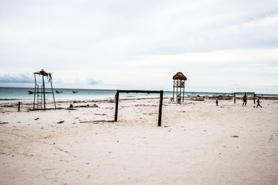 Lifeguard hut on beach against sky