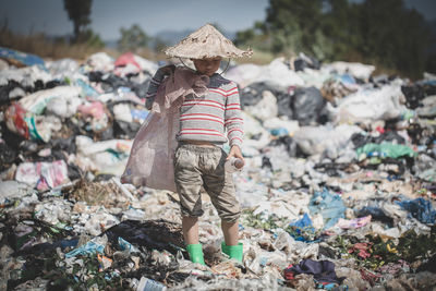 Poor children stand on garbage, human trafficking, child labor.