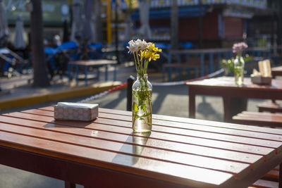 Beautiful flower decorations in glass on the table on the bar terrace