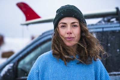 Woman surfer portrait with frozen surfboard