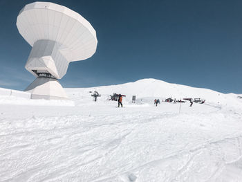 People walking on snow covered land