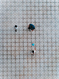 Directly above shot of father and kids playing on tiled floor