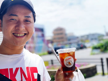 Portrait of smiling man holding drink