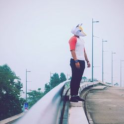 Full length of woman standing by railing