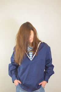 Young woman standing against white background